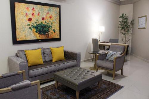 a living room with a couch and chairs and a table at Azul Talavera Country Club in Torreón