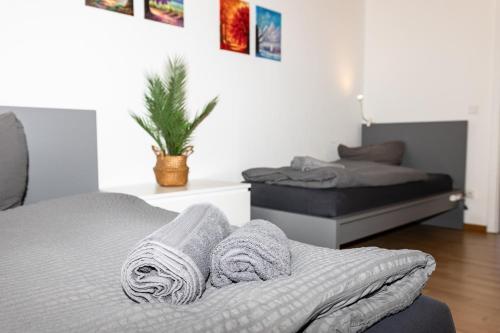 a bedroom with two beds and towels on a bed at CosyHomes24 - Centrally with balcony and parking space - GE09a in Gelsenkirchen