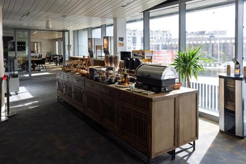an office with a counter with a cash register at Hôtel Lodge In Paris 13 in Paris