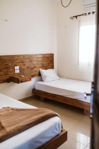a bedroom with two beds and a window at Anne 2 dahab in Dahab