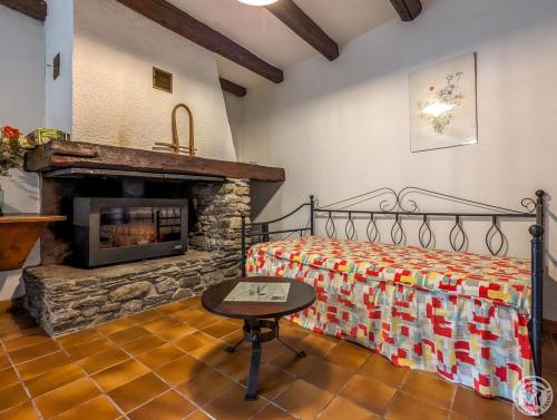 a bedroom with a bed and a fireplace at Le clos de bérande in Oô
