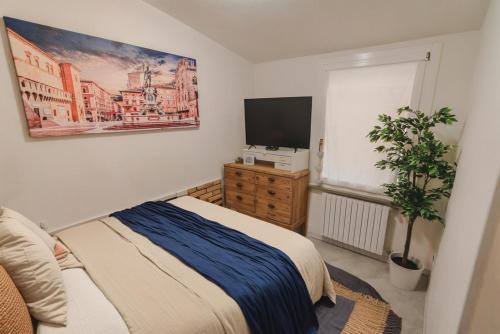 a bedroom with a bed and a flat screen tv at City Center - Casa luxury in Ravenna