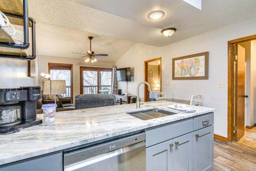 a kitchen with a counter top and a living room at Family-Friendly Condo 1 Mi to Silver Dollar City! in Branson West
