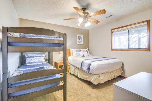 a bedroom with two bunk beds and a ceiling fan at Family-Friendly Condo 1 Mi to Silver Dollar City! in Branson West