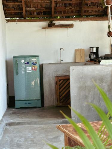a kitchen with a sink and a refrigerator at Villa Arugam Bay in Arugam Bay