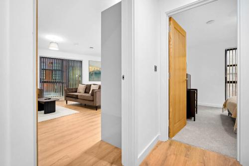 a hallway with a door leading to a living room at Stylish New 2-Bed Apartment in JQ in Birmingham
