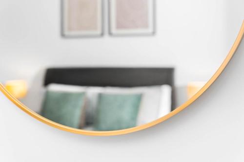 a mirror hanging on a wall in a room at Stylish New 2-Bed Apartment in JQ in Birmingham