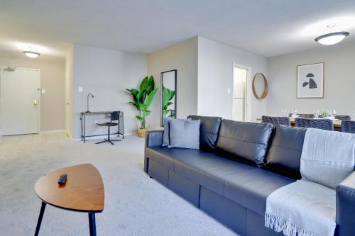 a living room with a blue couch and a table at This Apt is Perfect For Business Trips or a Relaxing Vacation in Arlington