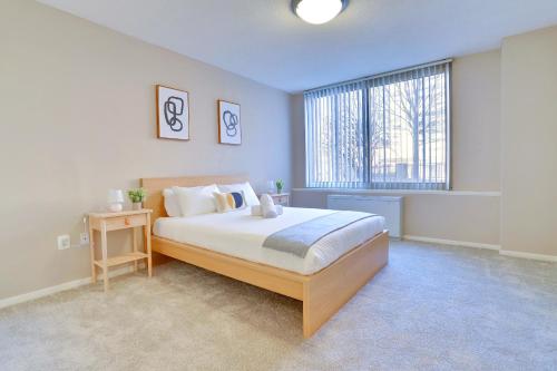a bedroom with a large bed and a large window at This Apt is Perfect For Business Trips or a Relaxing Vacation in Arlington