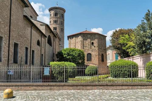 two towers of an old building with a fence at City Center - Casa luxury in Ravenna