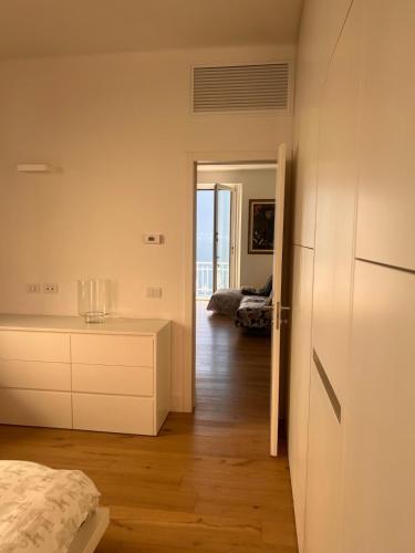 a bedroom with a bed and a view of a room at Special apartment on Lakeside in Colonno
