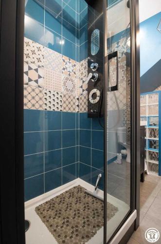 a bathroom with a shower with a glass door at La maison d'emy in Vernet
