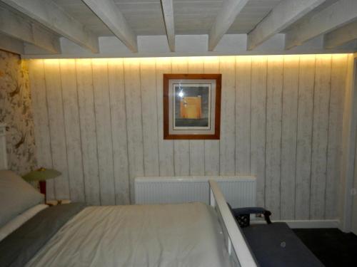 a bedroom with a bed and a picture on the wall at Adrigole Bay Studio Apartment in Adrigole