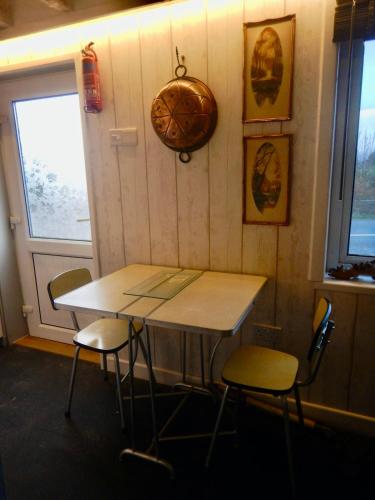 a table and chairs in a room with a window at Adrigole Bay Studio Apartment in Adrigole