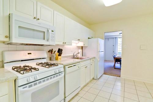 a kitchen with a white stove top oven next to a sink at Prime Location! Spacious & Comfy in Arlington