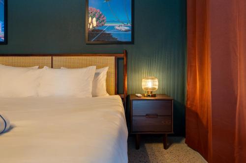 a bedroom with a bed and a lamp on a nightstand at Monaco Vacation Rentals in Clearwater Beach