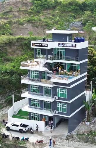 a building with a car parked in front of it at Yurich Hotel in Romblon
