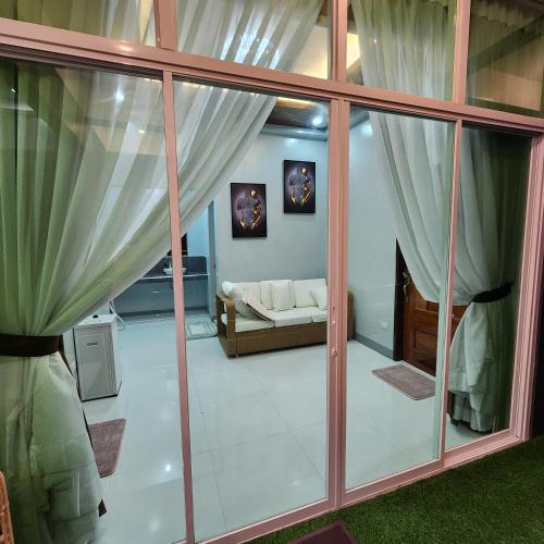 a living room with large glass windows and a couch at Yurich Hotel in Romblon