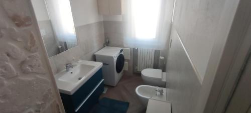a small bathroom with a sink and a toilet at La Piccola Casetta in Cisternino