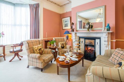 a living room with orange walls and a fireplace at Aberdeen Lodge in Dublin
