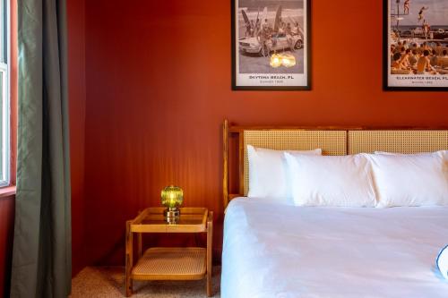 a bedroom with a bed and a table with a lamp at Monaco Vacation Rentals in Clearwater Beach