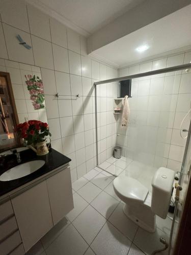 a bathroom with a shower and a toilet and a sink at Hospedaria HAPPY in Salinópolis