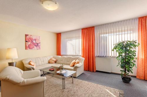 a living room with a couch and a table at Riedel Fronz in Lennestadt