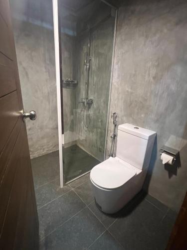a bathroom with a toilet and a shower at Eliyanth Udawalawe in Udawalawe