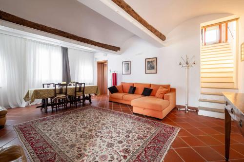 a living room with a couch and a table at Homeby, Villa Corte dello Zanchino in Zola Predosa