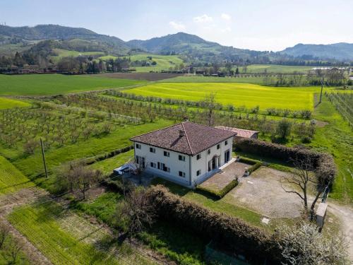 an aerial view of a white house in a field at Homeby, Villa Corte dello Zanchino in Zola Predosa