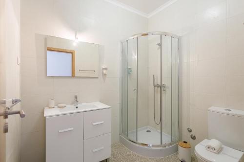 a bathroom with a shower and a sink and a toilet at Serene View - By SCH in Alvados