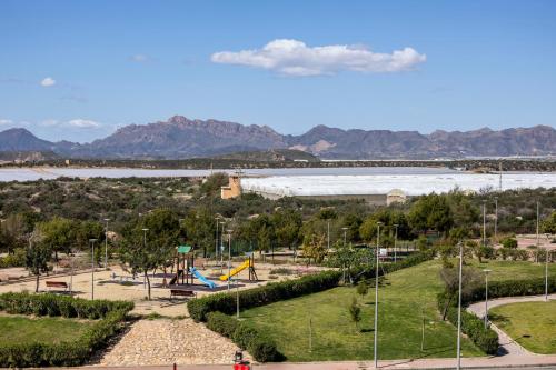 a park with a playground and a large lake at Apart Barlovento con piscina a 10 min de la playa in Águilas