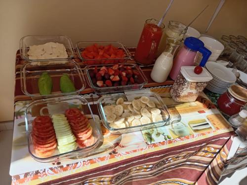 a table with several trays of food on it at Marlon's House Puno-Peru in Puno
