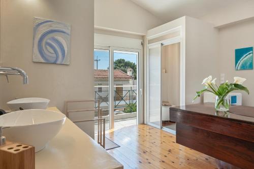 a bathroom with a sink and a toilet in a room at Artemida Beach House in Artemida