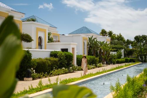 a woman stands in front of a villa at Banyan Tree Tamouda Bay in Fnidek