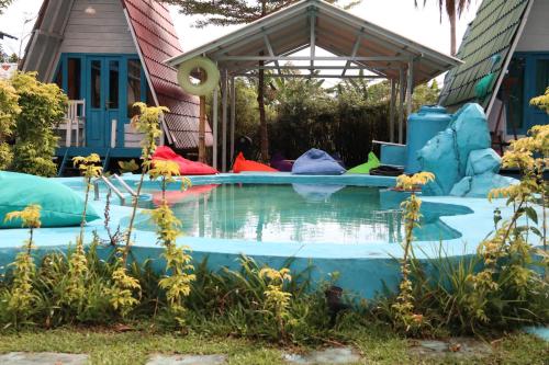 a pool in the backyard of a house at Tanjong Tinggi Cottage in Sijuk