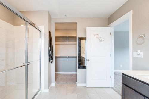 a bathroom with a shower and a glass door at 17 Mi to Denver Zoo Family-Friendly Aurora Home in Aurora