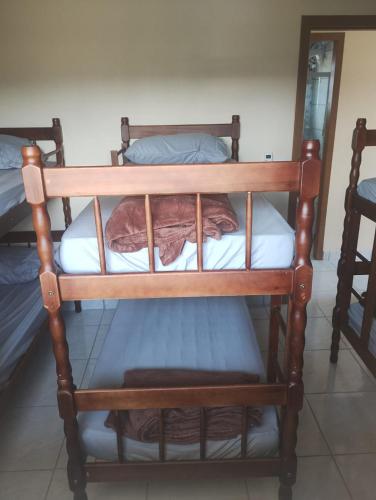 a couple of bunk beds in a room at Hostel Osoriense in Osório