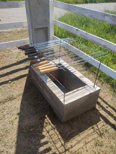 a grill with a bunch of hot dogs on it next to a fence at Hostel Osoriense in Osório