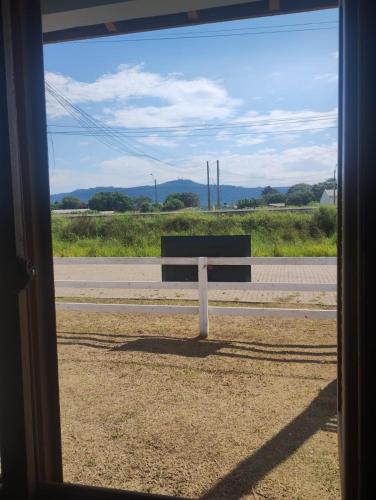 a bench sitting on the side of a road at Hostel Osoriense in Osório