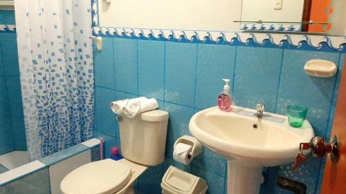 a bathroom with a toilet and a sink at Marlon's House Puno-Peru in Puno