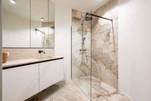 a bathroom with a shower and a sink at Unique penthouse with sublime sea views in Knokke-Heist