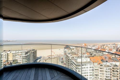 a balcony with a view of the beach and buildings at Unique penthouse with sublime sea views in Knokke-Heist