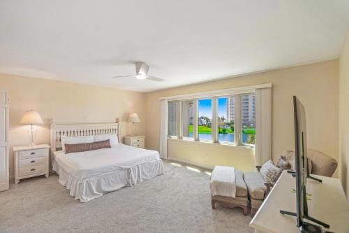 a bedroom with a bed and a large window at Seascape Boardwalk Villa 277 in Destin
