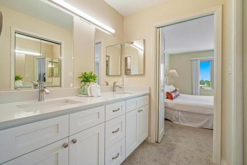 a bathroom with two sinks and a bedroom with a bed at Seascape Boardwalk Villa 277 in Destin