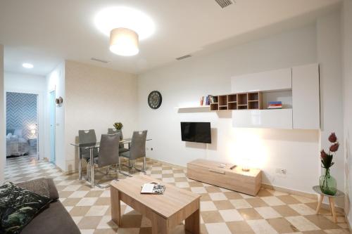 a living room with a couch and a table at ADANAR-Las Columnas in Granada