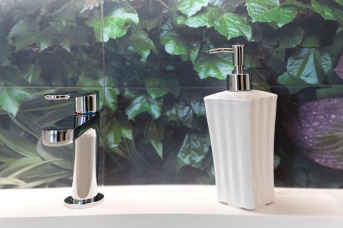 two white toothbrushes sitting on a bathroom sink at Dimore Trulli Holiday in Alberobello