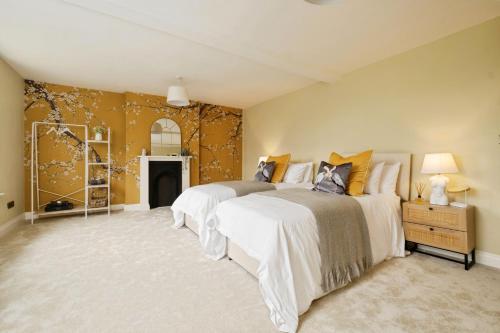 a bedroom with two beds and a fireplace at Holmer House Farm in Hereford