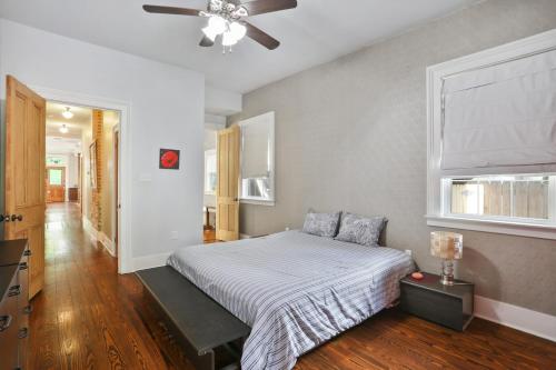 a bedroom with a bed and a ceiling fan at Eclectically furnished home in the heart of NOLA in New Orleans