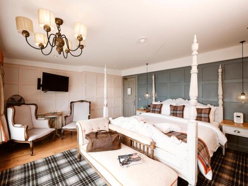 a bedroom with a large bed and a couch at Old Court House Inn in Saint Aubin